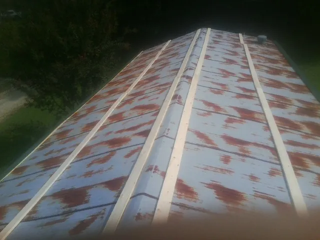 Rusted metal roof panels with new wood purlins before replacement — Storm Damage Roof Repair in Mayer by Roofing Brothers